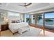 Spacious main bedroom boasts water views, a private balcony, and a tray ceiling at 443 18Th Ave, Indian Rocks Beach, FL 33785