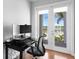 Home office with computer, desk, chair, and double doors leading to patio and outside views at 443 18Th Ave, Indian Rocks Beach, FL 33785