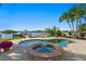 View of pool and spa overlooking waterfront with boat lift and manicured landscaping at 443 18Th Ave, Indian Rocks Beach, FL 33785