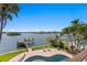 Aerial view of the beautiful swimming pool overlooking the waterfront with a boat lift at 443 18Th Ave, Indian Rocks Beach, FL 33785