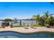 Poolside view of waterfront featuring manicured landscape, boatlift, chairs and flowers at 443 18Th Ave, Indian Rocks Beach, FL 33785