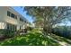 Backyard view of property with well-maintained lawn and walking path at 4560 Overlook Ne Dr # 168, St Petersburg, FL 33703