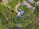Aerial view of a home with pool nestled among lush, mature trees at 48 Bishop Creek Dr, Safety Harbor, FL 34695