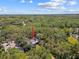 Aerial view of property nestled in trees, highlighting the pool at 48 Bishop Creek Dr, Safety Harbor, FL 34695