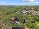 Aerial view of a wooded community showing a home nestled among mature trees at 48 Bishop Creek Dr, Safety Harbor, FL 34695