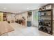 A brightly lit workshop in the basement featuring tile flooring and storage shelves at 48 Bishop Creek Dr, Safety Harbor, FL 34695