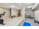 Open basement space with gym equipment, neutral walls, and tile flooring at 48 Bishop Creek Dr, Safety Harbor, FL 34695