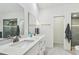 Bright bathroom with double sinks, a shower, and modern design at 48 Bishop Creek Dr, Safety Harbor, FL 34695