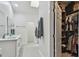 Bathroom with a double sink vanity, walk-in closet, and modern fixtures at 48 Bishop Creek Dr, Safety Harbor, FL 34695