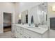 Bathroom featuring double sinks and a doorway into an adjoining bedroom at 48 Bishop Creek Dr, Safety Harbor, FL 34695