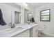 Bright bathroom with double sinks, quartz countertop, and modern fixtures offers style and functionality at 48 Bishop Creek Dr, Safety Harbor, FL 34695