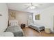 Well-lit bedroom showcases twin beds, hardwood floors, and neutral decor for a serene atmosphere at 48 Bishop Creek Dr, Safety Harbor, FL 34695