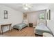 Bright bedroom featuring two twin beds, wood floors, and a ceiling fan for added comfort at 48 Bishop Creek Dr, Safety Harbor, FL 34695