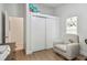 Bright Bedroom with a comfortable rocking chair, closet, and charming decorative mobile at 48 Bishop Creek Dr, Safety Harbor, FL 34695