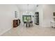 Bright dining room featuring a modern chandelier and herringbone-patterned floors at 48 Bishop Creek Dr, Safety Harbor, FL 34695