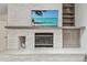 Close up of a modern stone fireplace with built-in shelving and a mounted television at 48 Bishop Creek Dr, Safety Harbor, FL 34695