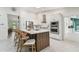 Modern kitchen featuring a large island with seating and stainless steel appliances at 48 Bishop Creek Dr, Safety Harbor, FL 34695