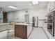 Stylish kitchen with a center island, stainless steel appliances, and sleek cabinetry at 48 Bishop Creek Dr, Safety Harbor, FL 34695
