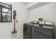 Well-equipped laundry area with a washer, dryer, and convenient wall-mounted vacuum at 48 Bishop Creek Dr, Safety Harbor, FL 34695