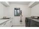Functional laundry room with modern appliances, ample counter space, and natural light at 48 Bishop Creek Dr, Safety Harbor, FL 34695