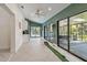 Bright living room features herringbone floors, a mini-kitchenette, and access to a screened porch and pool at 48 Bishop Creek Dr, Safety Harbor, FL 34695