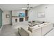 Bright living room features a stone fireplace and comfortable sectional seating at 48 Bishop Creek Dr, Safety Harbor, FL 34695