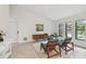 Open living room features bright windows, sleek floors, and comfortable seating at 48 Bishop Creek Dr, Safety Harbor, FL 34695