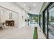 Bright living room with herringbone floors, and access to a mini-kitchenette, dining room and screened porch at 48 Bishop Creek Dr, Safety Harbor, FL 34695