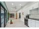 Bright living room boasts herringbone floors, a mini-kitchenette and access to a screened porch and other rooms at 48 Bishop Creek Dr, Safety Harbor, FL 34695