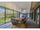Inviting screened-in patio with dining area and views of the lush backyard at 48 Bishop Creek Dr, Safety Harbor, FL 34695