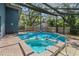 Relaxing pool and jacuzzi area with a screened enclosure for year-round enjoyment at 48 Bishop Creek Dr, Safety Harbor, FL 34695