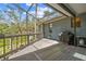 Outdoor screened porch with a barbecue grill and views of mature trees and a blue sky at 48 Bishop Creek Dr, Safety Harbor, FL 34695