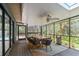 Inviting screened porch features a dining area with a ceiling fan and views of the lush landscaping at 48 Bishop Creek Dr, Safety Harbor, FL 34695