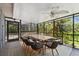 Spacious screened porch with dining area and lush backyard views, creating a serene outdoor space at 48 Bishop Creek Dr, Safety Harbor, FL 34695