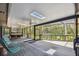 Expansive screened porch with dining and lounging areas, offering seamless indoor-outdoor living at 48 Bishop Creek Dr, Safety Harbor, FL 34695