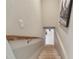 View of the staircase leading down, featuring light-colored walls and a wooden handrail at 48 Bishop Creek Dr, Safety Harbor, FL 34695