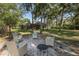 Spacious backyard with mature trees and an inviting seating area at 502 Creekside Ct, Safety Harbor, FL 34695
