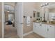 Bathroom showcasing white vanity with granite countertop, modern fixtures, and an open bedroom at 502 Creekside Ct, Safety Harbor, FL 34695