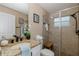 Nicely appointed bathroom featuring granite counters, decorative accessories, and a tile shower at 502 Creekside Ct, Safety Harbor, FL 34695
