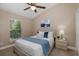 Cozy bedroom featuring a queen-sized bed, a ceiling fan, and a sun-filled window at 502 Creekside Ct, Safety Harbor, FL 34695