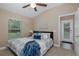 Comfortable bedroom with light walls, ceiling fan, and natural light at 502 Creekside Ct, Safety Harbor, FL 34695
