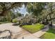 Stately home featuring a manicured lawn, grand trees, and a spacious driveway at 502 Creekside Ct, Safety Harbor, FL 34695