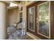 Close-up of front porch with chairs and detailed glass front door at 502 Creekside Ct, Safety Harbor, FL 34695