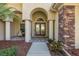 Inviting front porch with stone accents, columns, and a 'Welcome' sign at 502 Creekside Ct, Safety Harbor, FL 34695