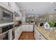 Kitchen featuring stainless steel appliances, white cabinets, hardwood floors, and modern lighting at 502 Creekside Ct, Safety Harbor, FL 34695