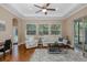 Comfortable living room with lots of natural light, hardwood floors, and neutral colored furniture at 502 Creekside Ct, Safety Harbor, FL 34695