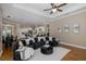 Open concept living room flows into the kitchen, featuring a large sofa and hardwood floors at 502 Creekside Ct, Safety Harbor, FL 34695