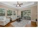 Bright living room with lots of natural light, hardwood floors, and a white leather sofa at 502 Creekside Ct, Safety Harbor, FL 34695