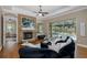 Open living room with a fireplace, hardwood floors, and sliders that open to the pool at 502 Creekside Ct, Safety Harbor, FL 34695