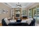 Open living room with a fireplace, hardwood floors, and plenty of natural light at 502 Creekside Ct, Safety Harbor, FL 34695
